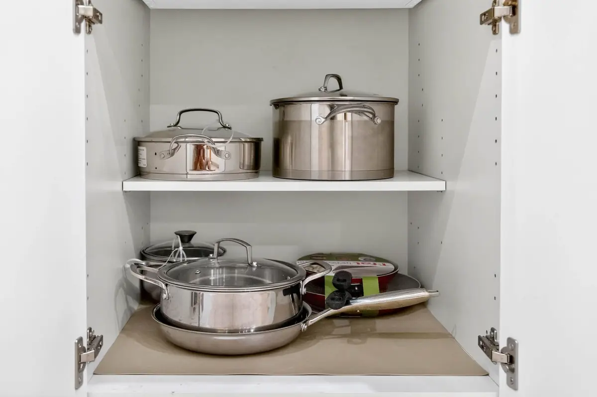 Cabinet stocked with pots and pans