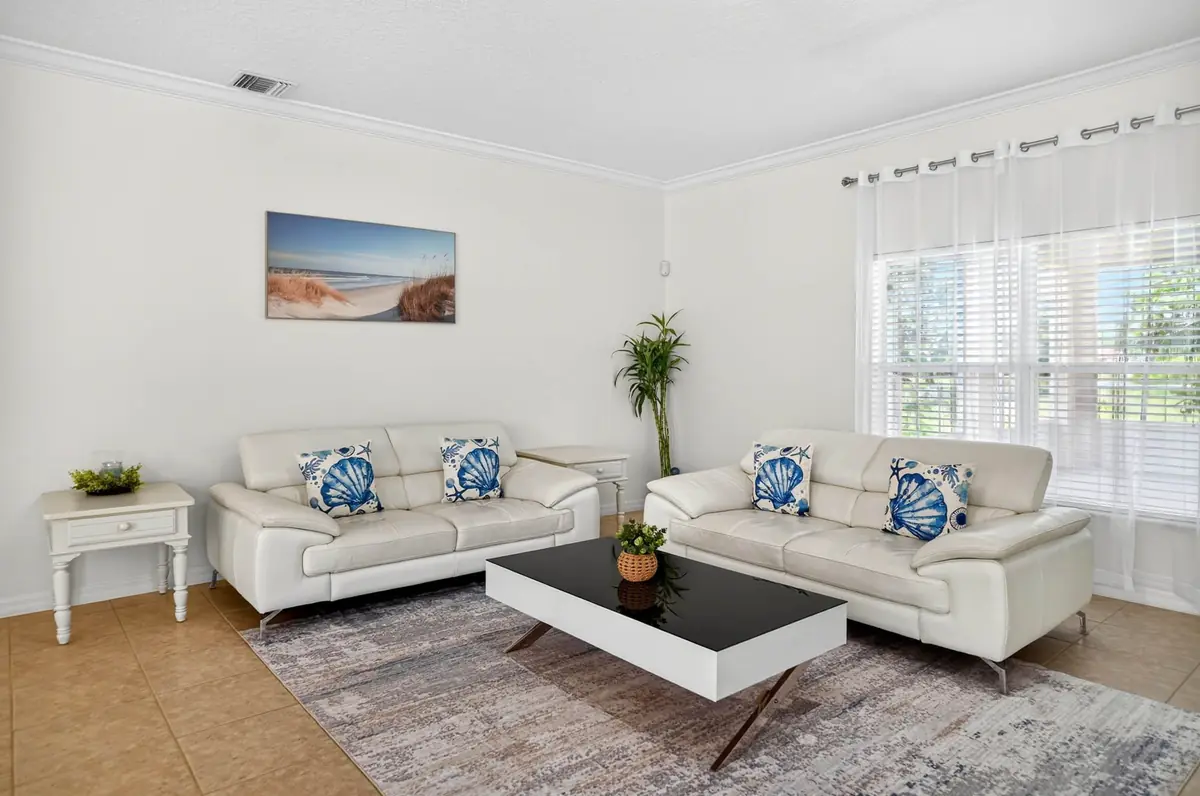 Second sitting area with sofas near a large window