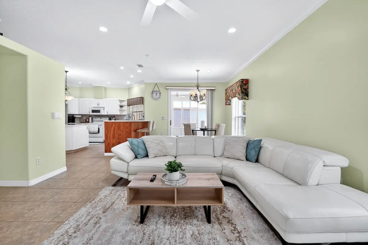 Open living room with a white sectional sofa and TV